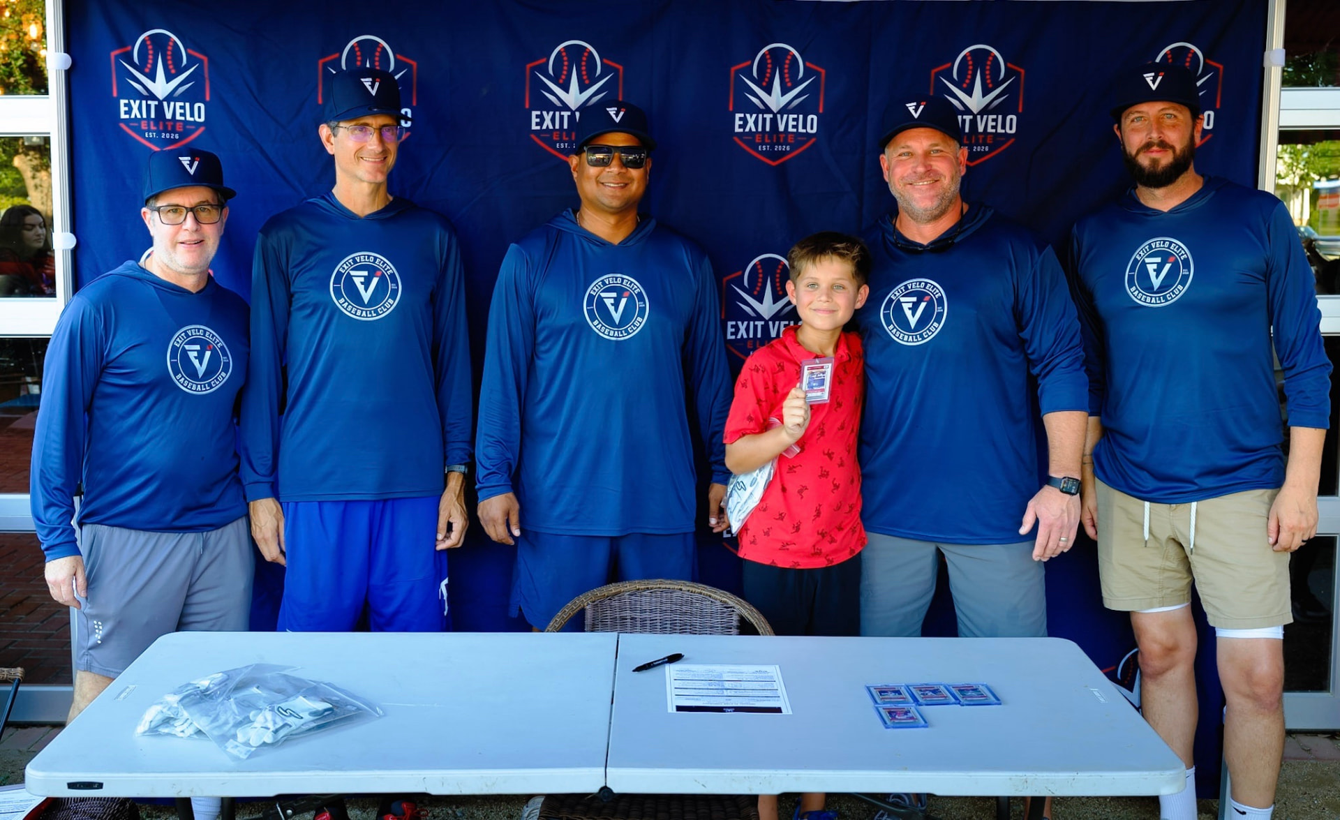 Coaches and a new player at the signing table
