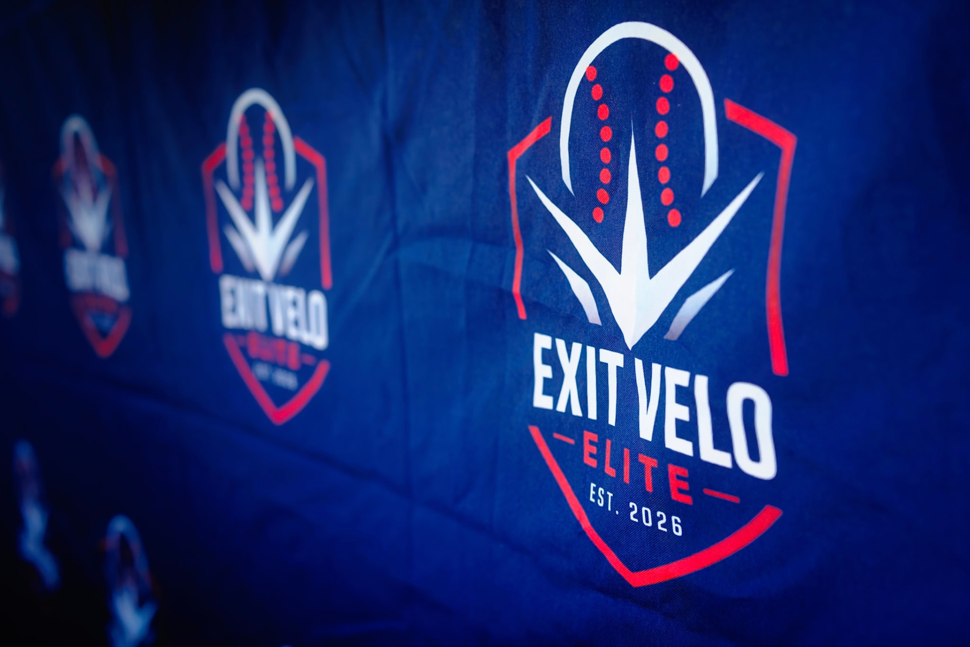 Exit Velo Elite banner on team tent
