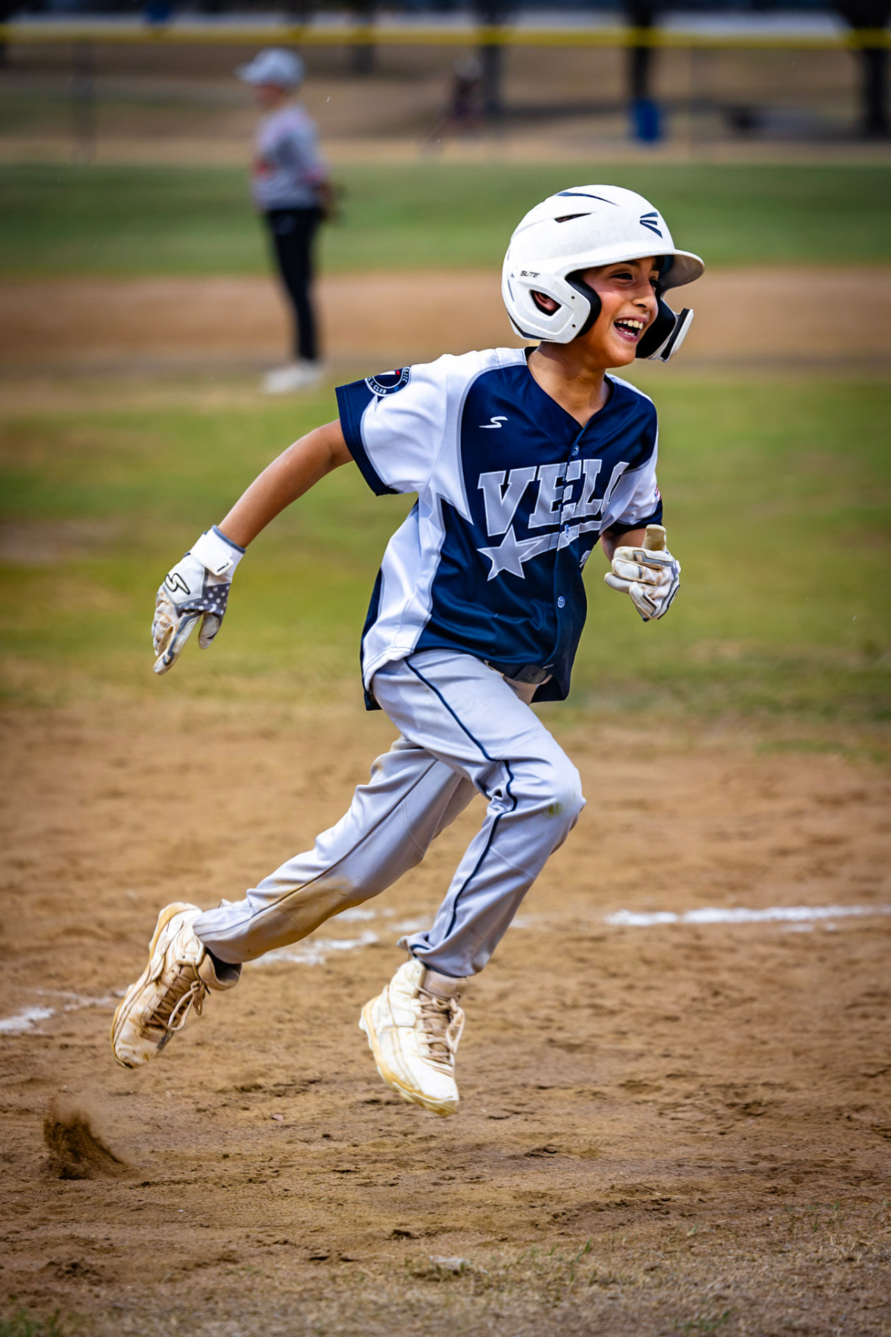 Asher Rogers smiling as he runs the bases for Exit Velo Elite