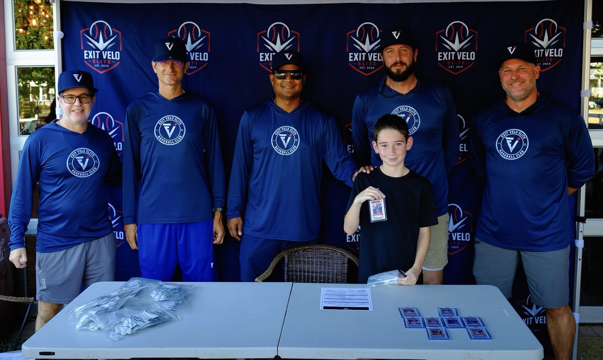 Coaches with a signee showing his graded card