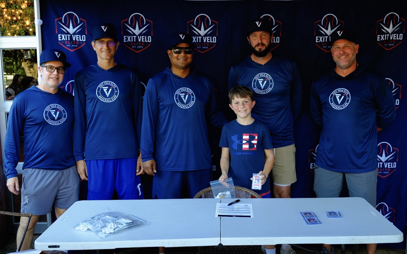 Coaching staff with a signee holding his ZDecks card