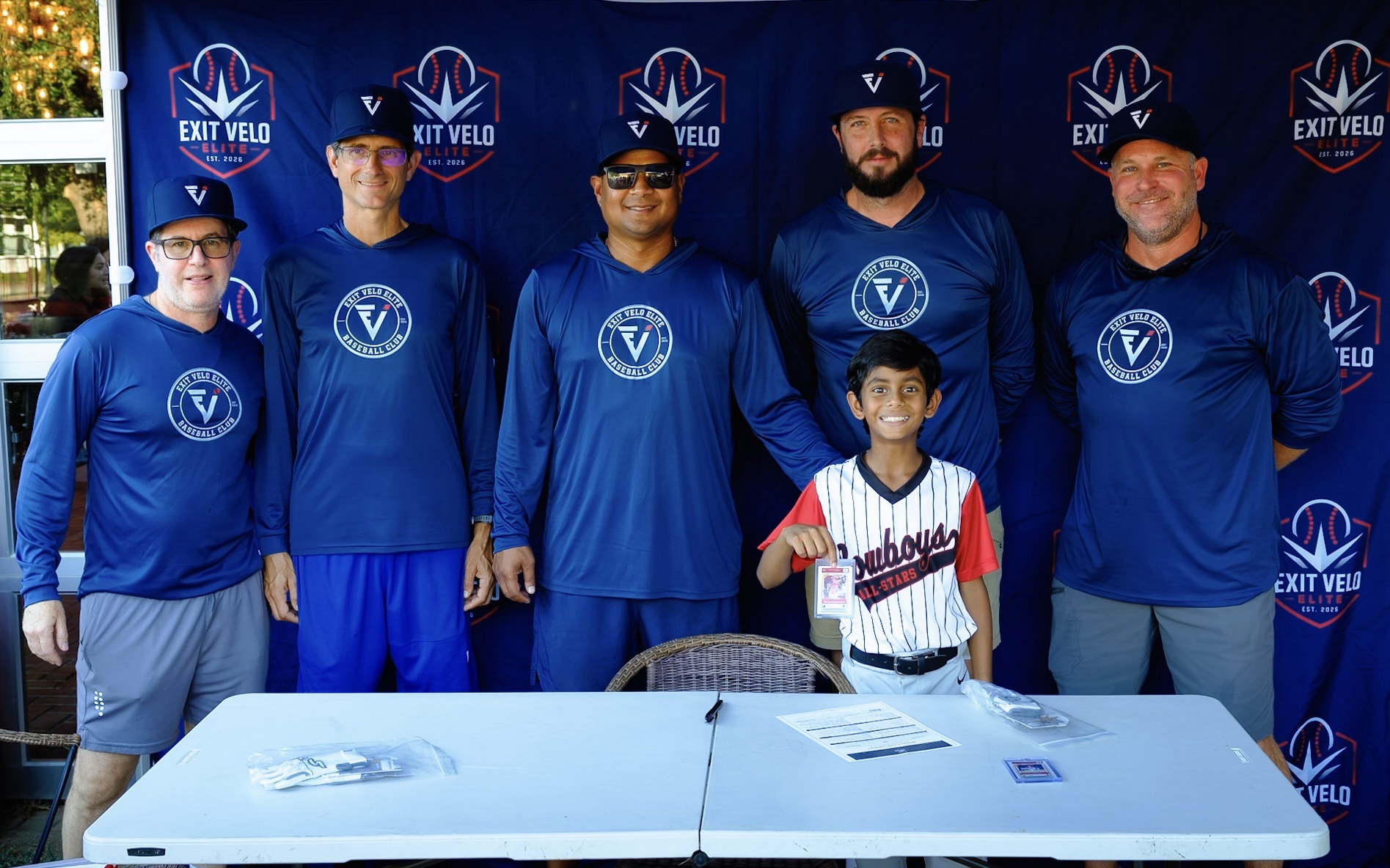 Coaching staff with a new signee holding his ZDecks card