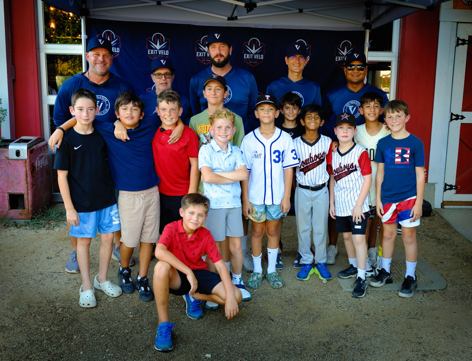 Exit Velo Elite team gathered under the club tent